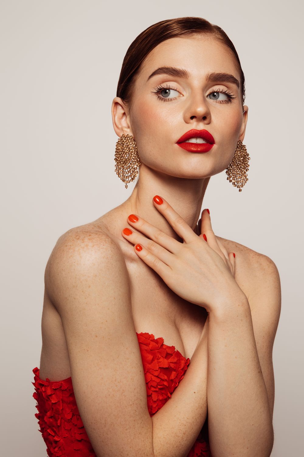 Model with red dress and bold makeup.