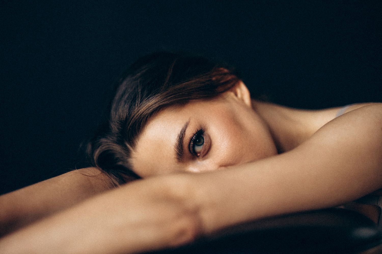 Close-up of a woman resting her head.